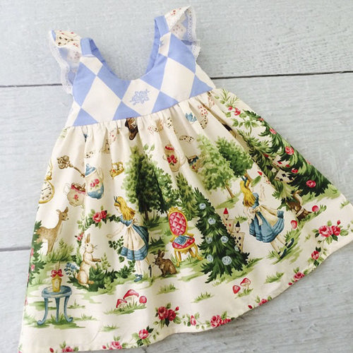 This adorable vintage inspired fabric Alice in Wonderland dress is a must have for all you Disney fans! The lace eyelet detailing on the sleeves adds to that retro vintage vibe. 